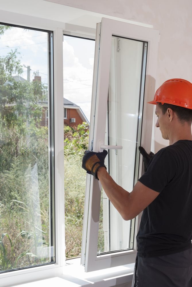 A man is installing a window in a house — Reflect Glass In Tuggerah, NSW