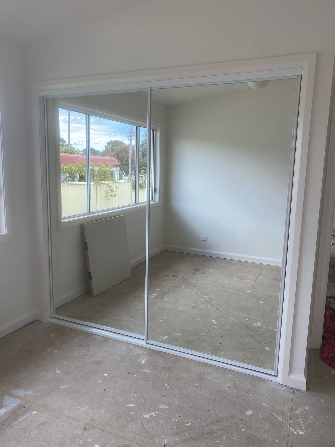 A Room with A Large Mirror on The Wall — Reflect Glass In Tuggerah, NSW