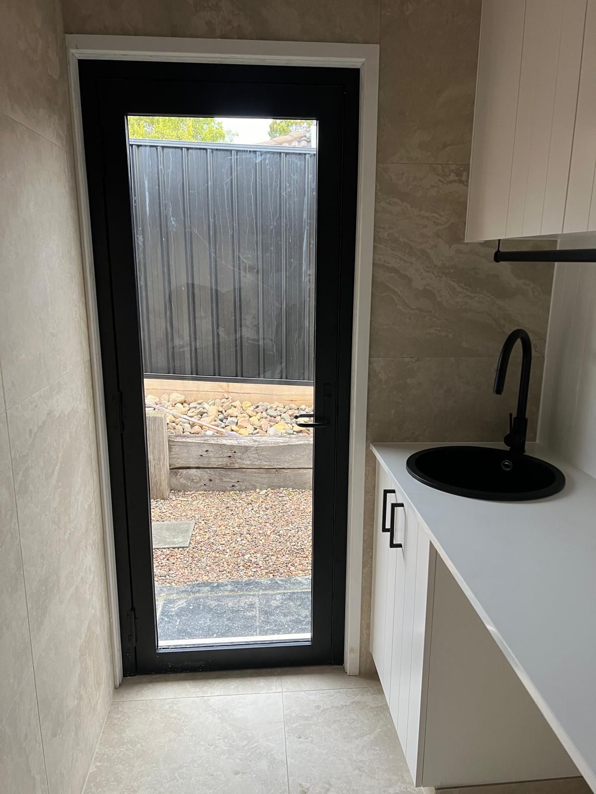 A Kitchen with A Black Door and A Sink — Reflect Glass In Tuggerah, NSW