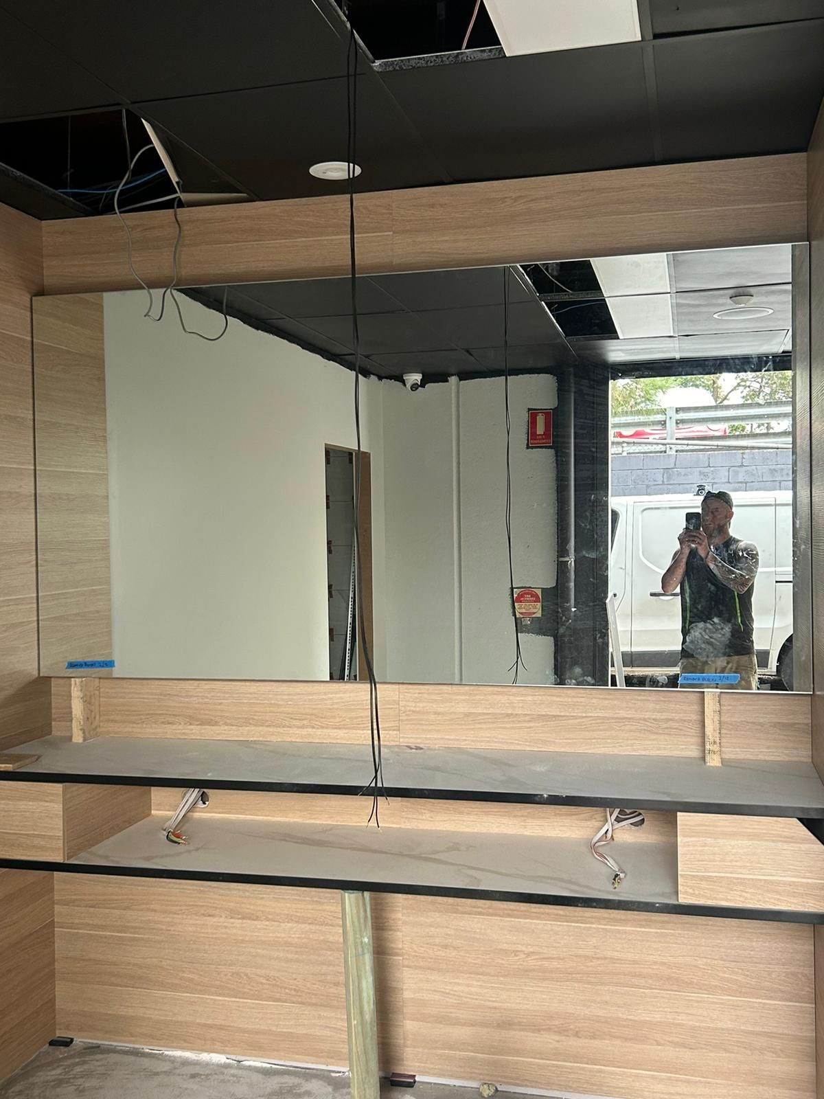 A Man Is Taking a Picture of Himself in A Mirror — Reflect Glass In Tuggerah, NSW