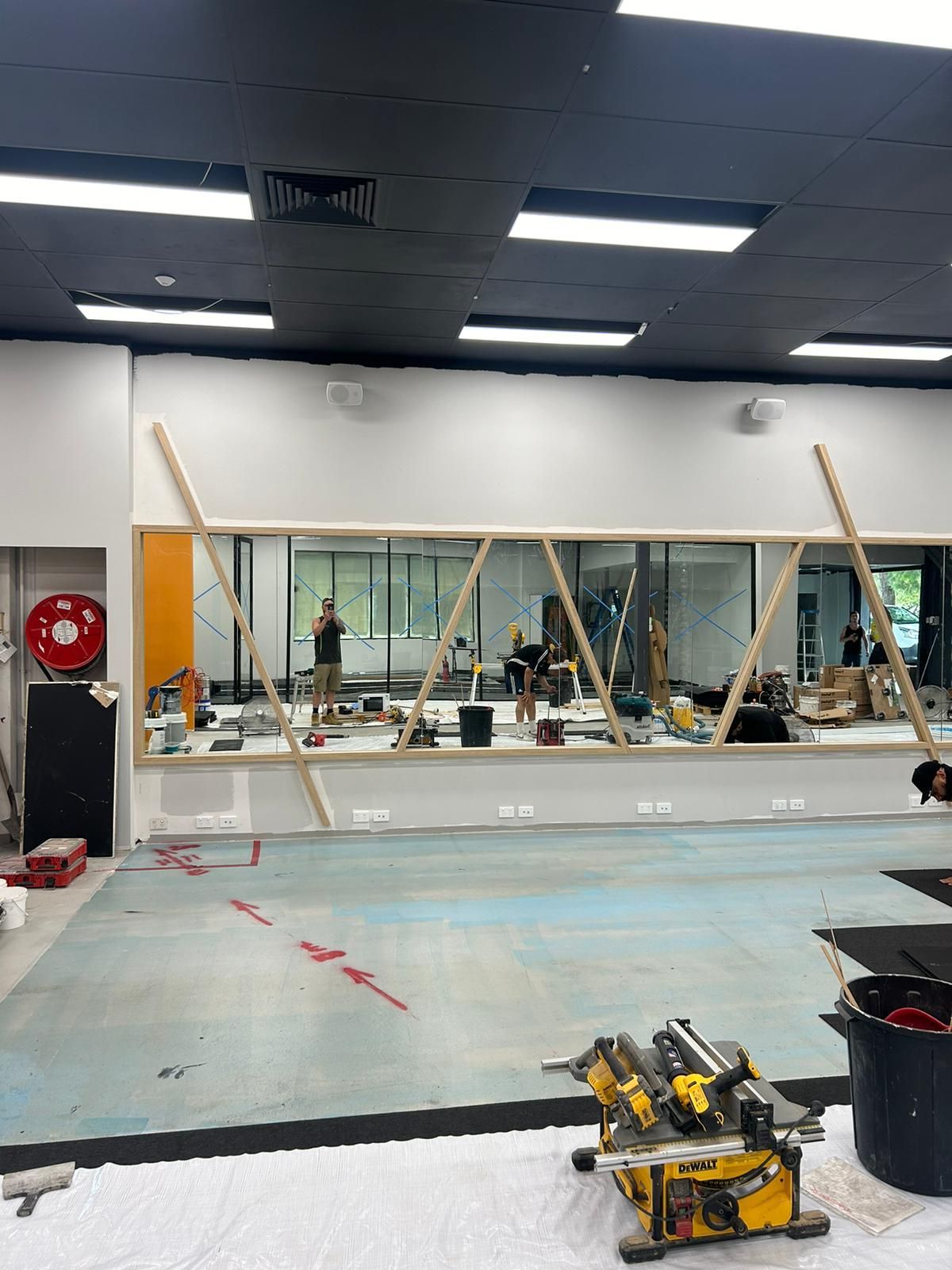 A Large Mirror Is Being Installed in A Gym — Reflect Glass In Tuggerah, NSW