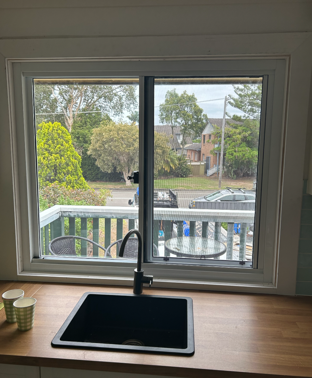 A Kitchen with A Sink and A Window with A View of A Balcony — Reflect Glass In Tuggerah, NSW