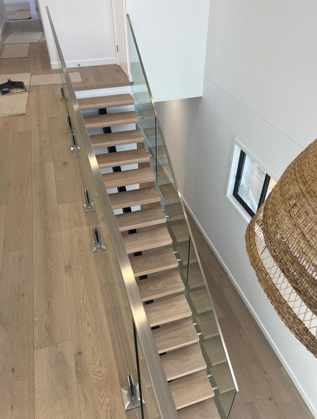 An Aerial View of A Wooden Staircase with A Glass Railing — Reflect Glass In Tuggerah, NSW