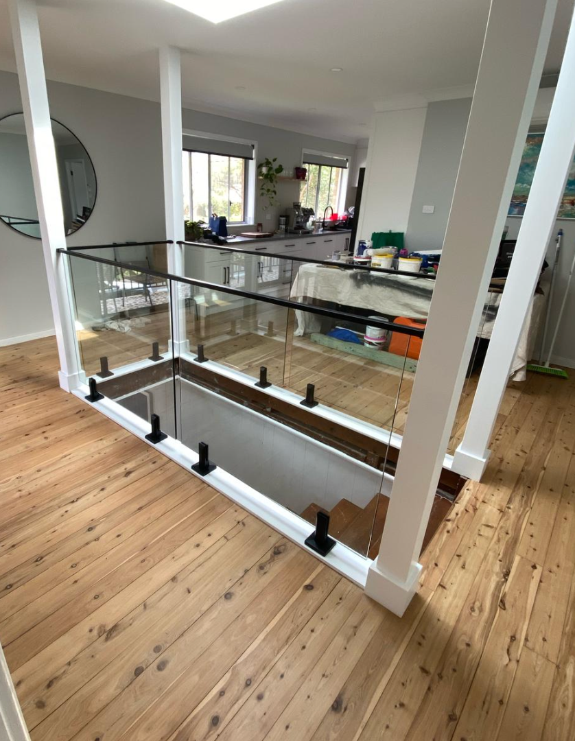 A Staircase with A Glass Railing and Wooden Floors — Reflect Glass In Tuggerah, NSW