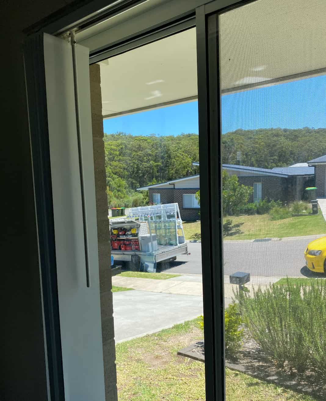 A Sliding Glass Door with A Screen on It — Reflect Glass In Tuggerah, NSW