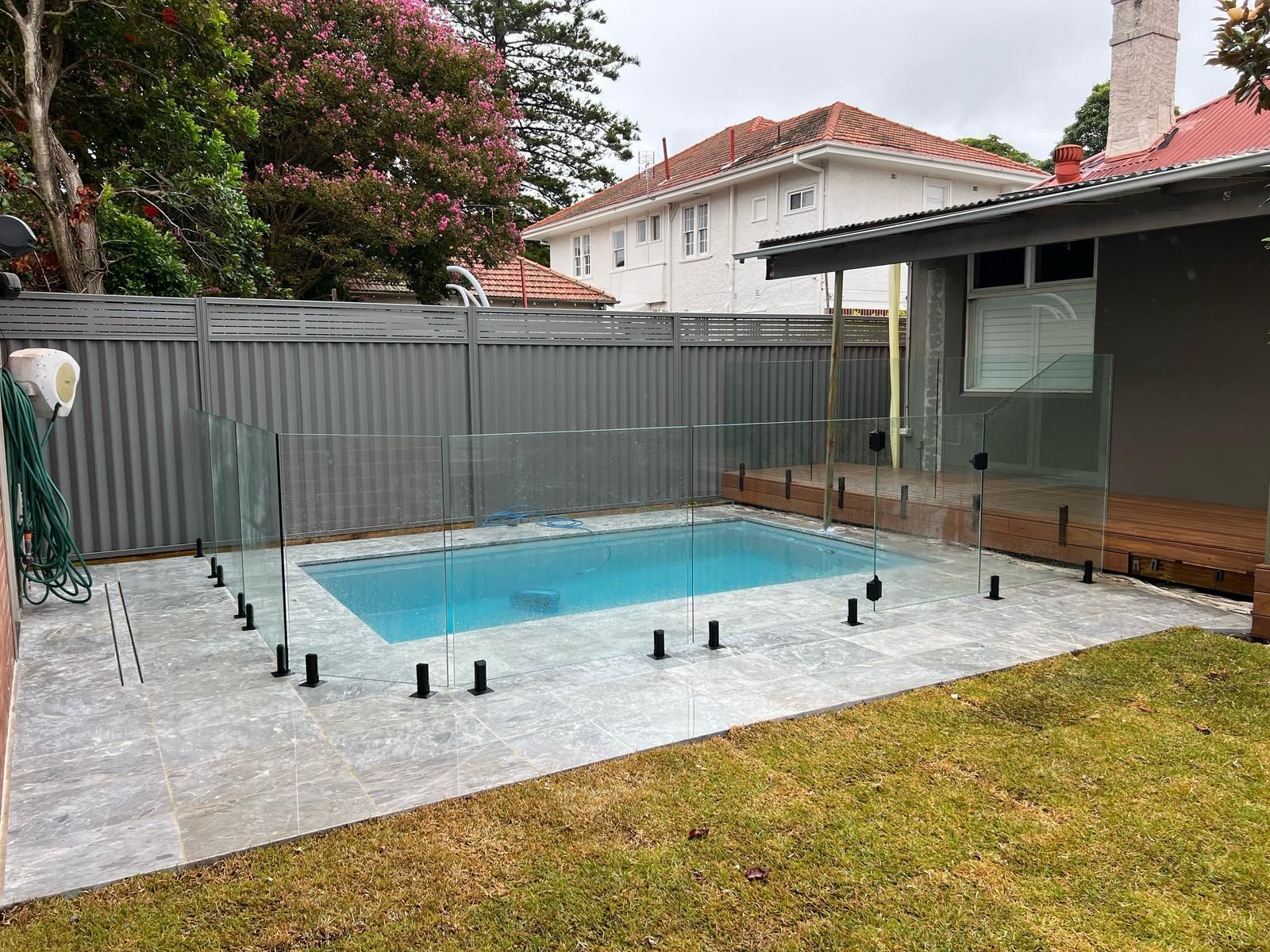 A Swimming Pool in The Backyard of A House — Reflect Glass In Tuggerah, NSW