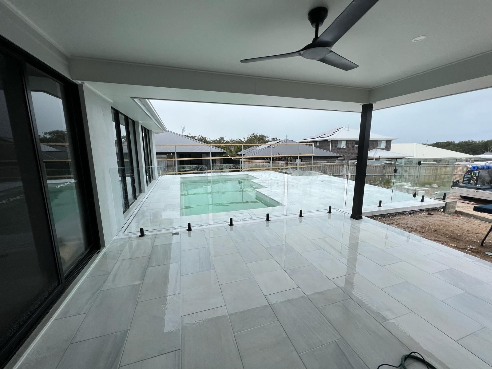 A Patio with A Ceiling Fan and A Swimming Pool — Reflect Glass In Tuggerah, NSW