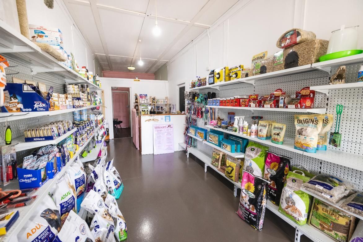 A Store Filled With Lots of Shelves and Bags of Food — Fluffy Paws Pet Grooming In Wingham, NSW