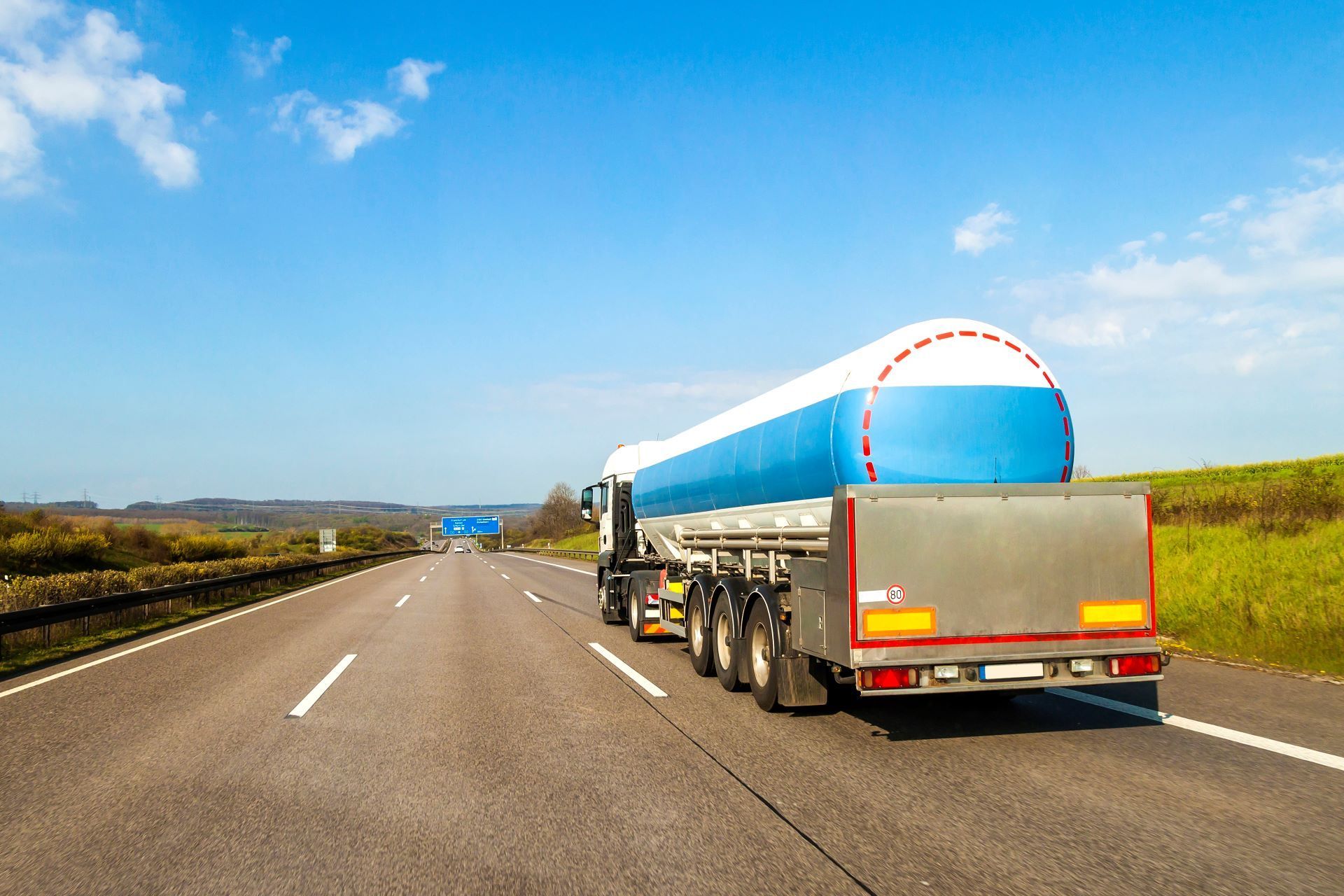 A tanker truck is driving down a highway.