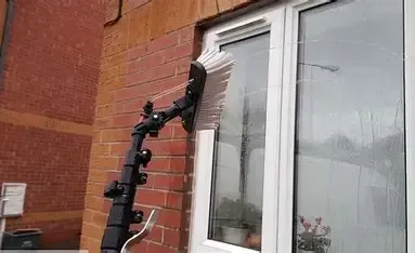 Cleaning a window with a squeegee. Window cleaning helps with curb appeal as well as a nicer feel inside the home.