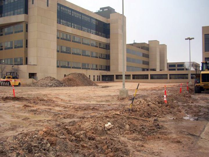 A large building with a lot of dirt in front of it