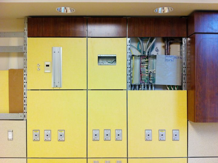 A yellow wall with a clock on it