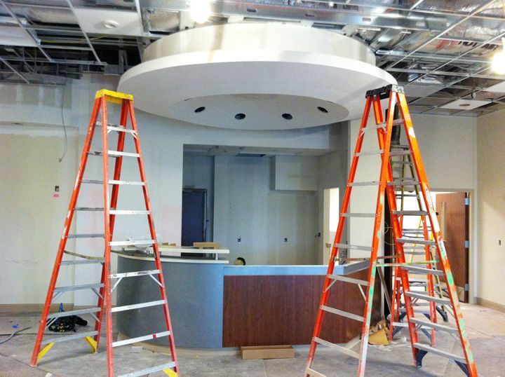 Two ladders are sitting in a room under construction
