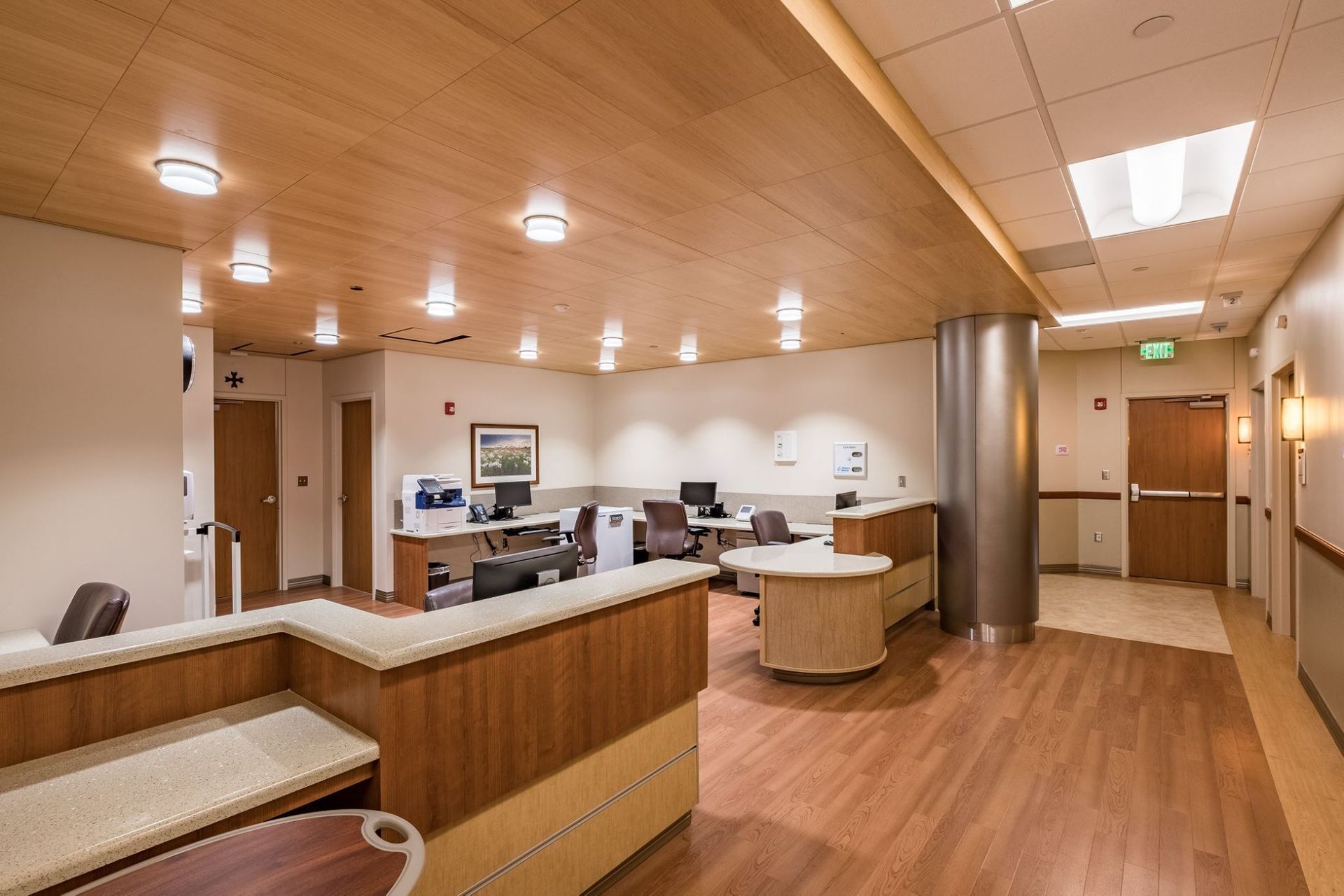 A hospital waiting room with wooden floors and a wooden counter
