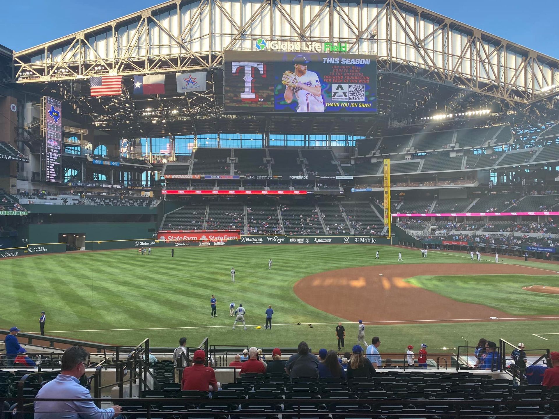 A baseball stadium with a large screen that says t on it