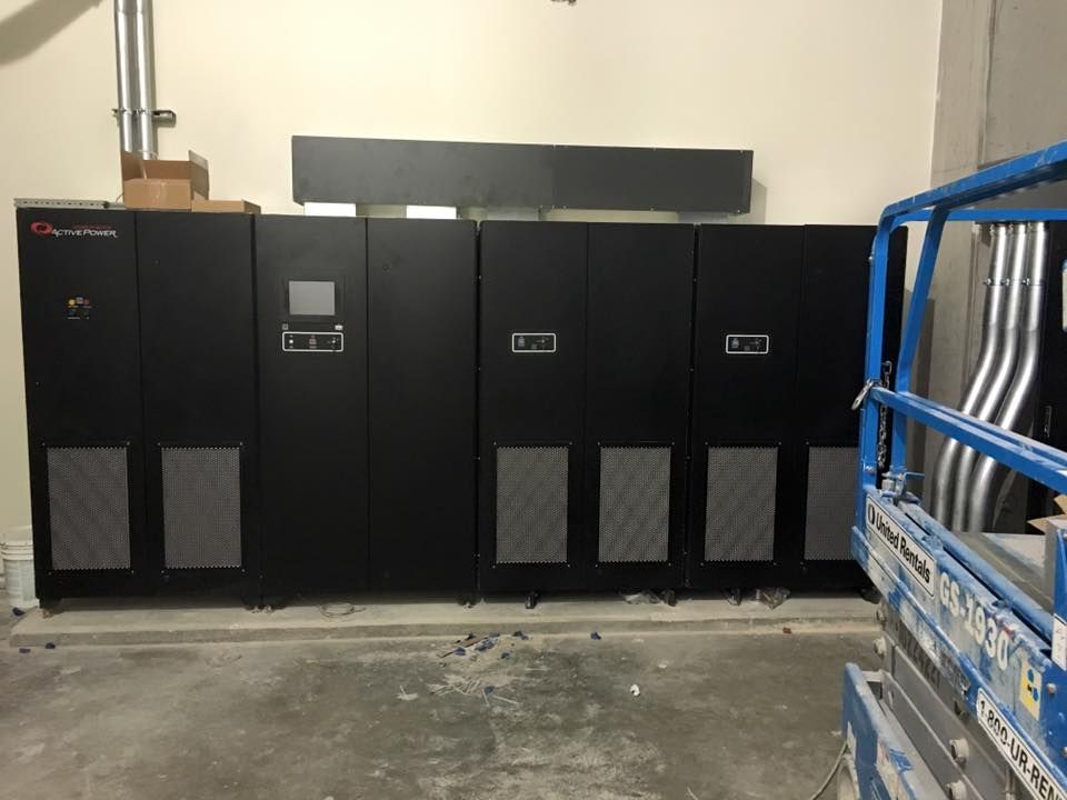 A room with a lot of black cabinets and a blue lift