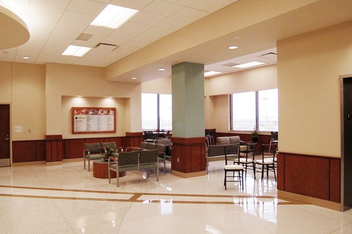 A waiting room with chairs and a sign that says service