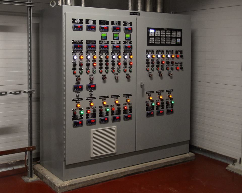 A large electrical control panel with a lot of buttons on it