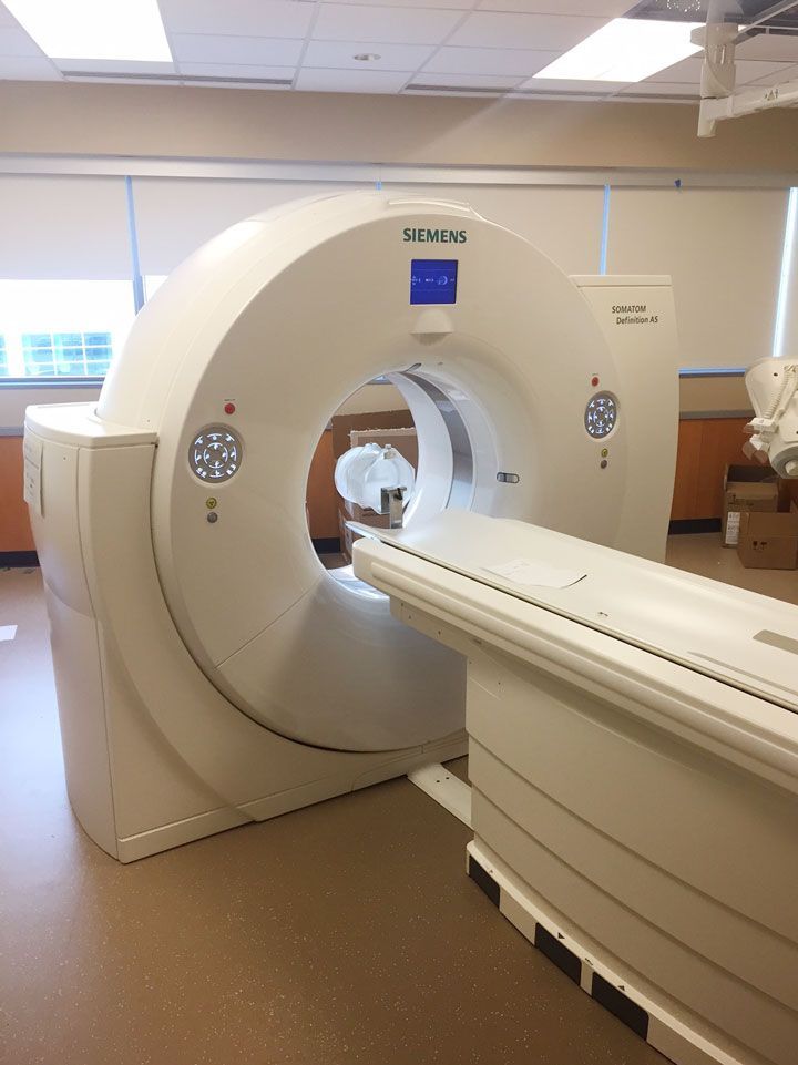 A siemens ct scan machine is sitting in a hospital room.