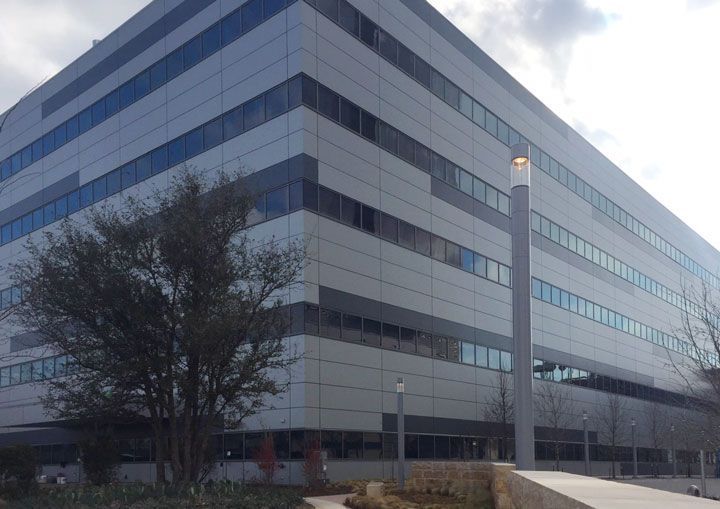 A large building with a lot of windows and trees in front of it