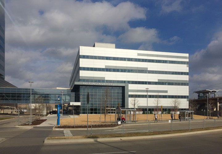 A large white building with a blue sky in the background