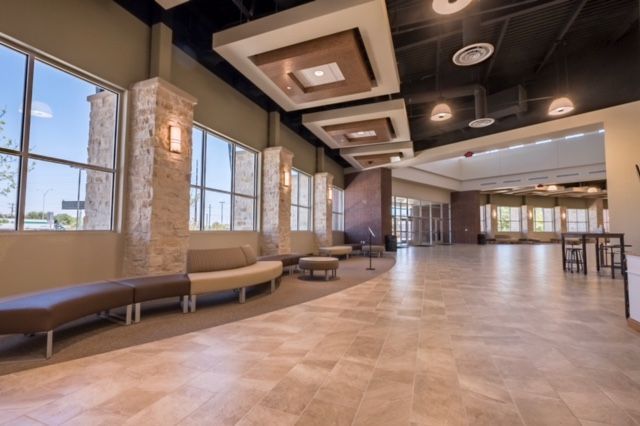 A large room with a lot of windows and a couch.