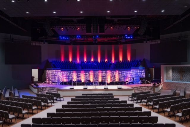 An empty auditorium with rows of seats and a stage
