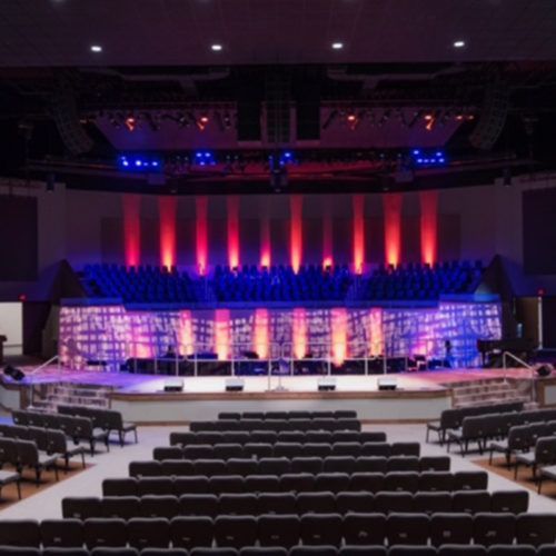 A large auditorium with rows of seats and a stage