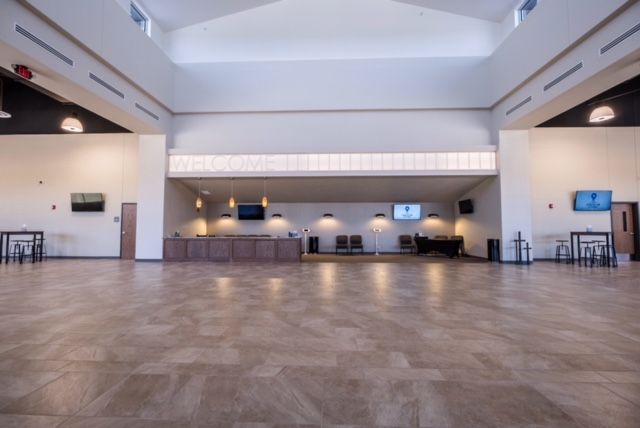 A large empty room with a wooden floor and white walls