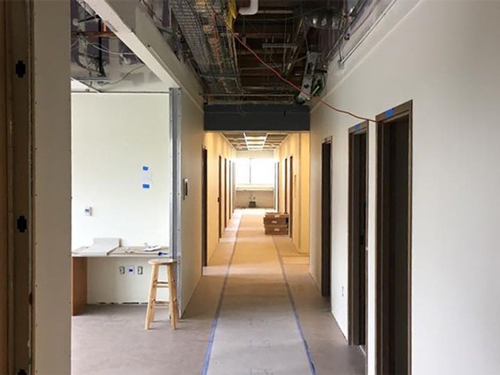 A long hallway in a building under construction.