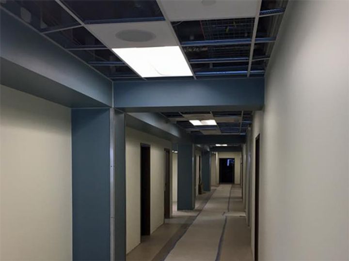 A long hallway with a light on the ceiling