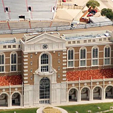An aerial view of a large brick building with arched windows