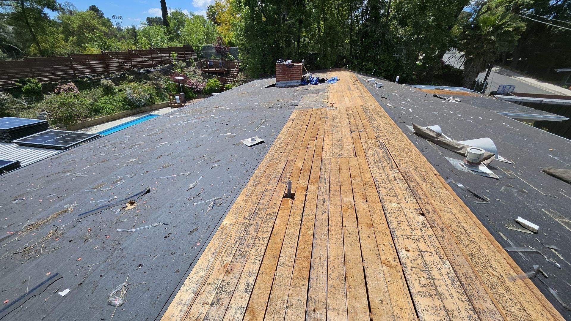 A wooden deck is being built on top of a roof