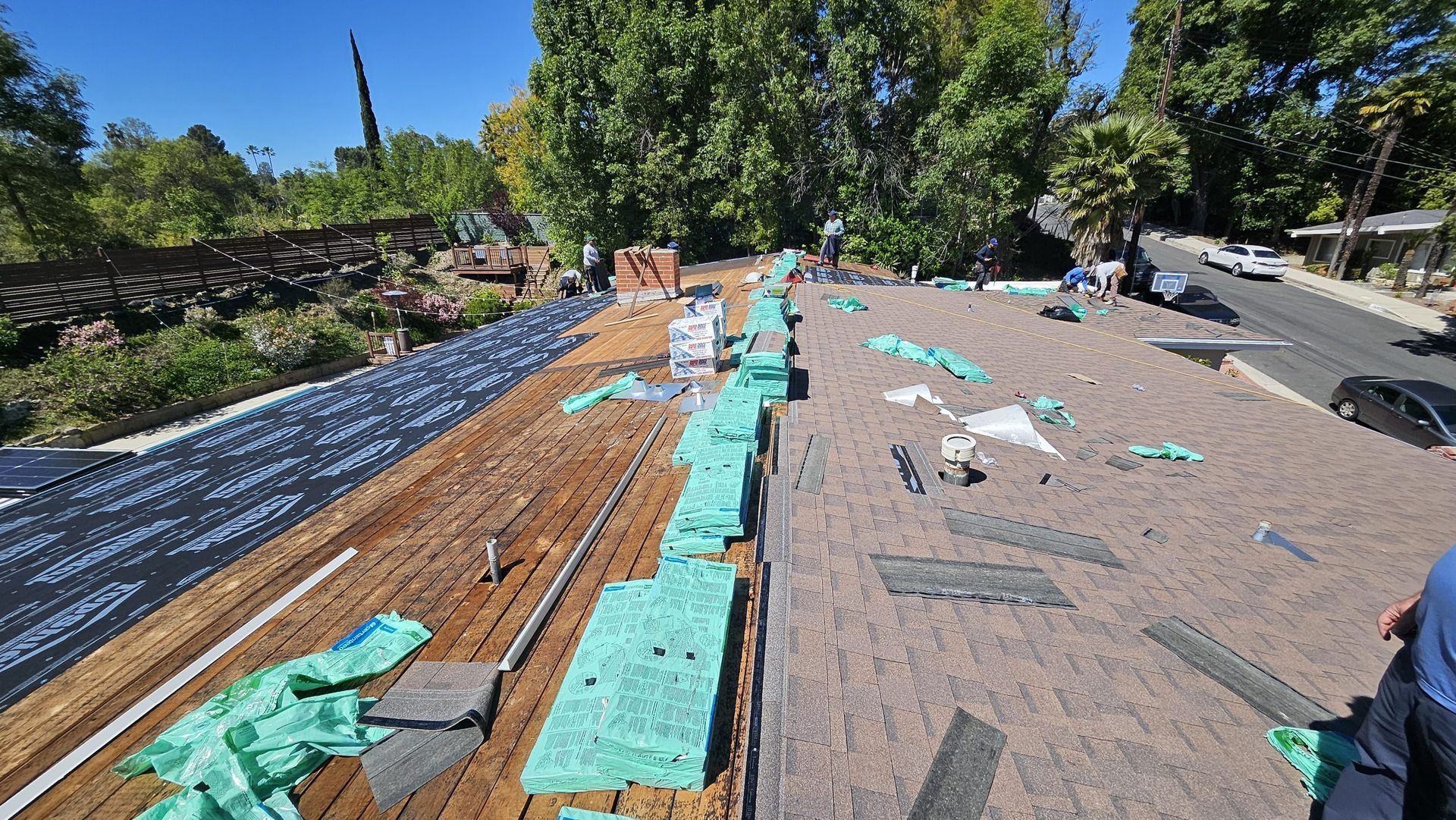 A roof is being repaired with a lot of green foam on it.