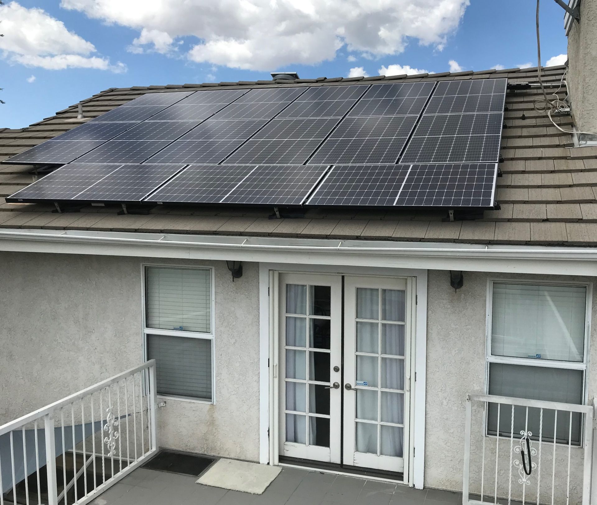 A house with a lot of solar panels on the roof