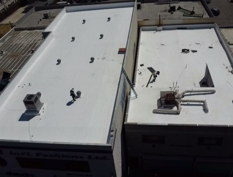 An aerial view of a building with a white roof