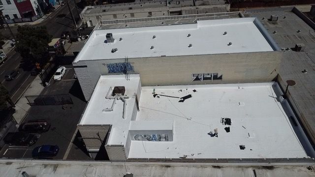 An aerial view of a building with a white roof.