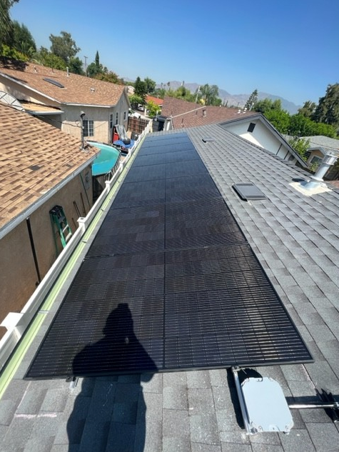 A solar panel is on the roof of a house