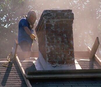 Man Cleaning Chimney — Brown's Chimney Service in Bend, OR