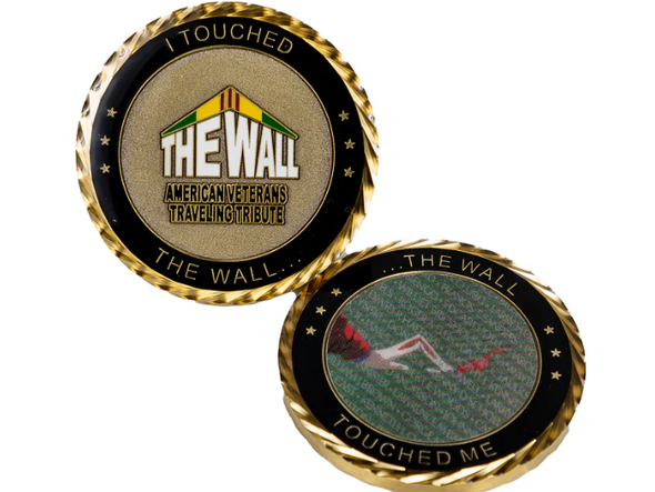 A coin that says i touched the wall on it