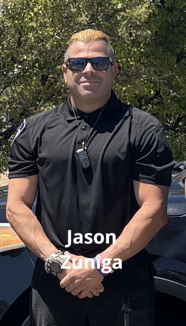 Jason Zuniga, a man with sunglasses and blond-streaked hair, poses outdoors wearing a black uniform.
