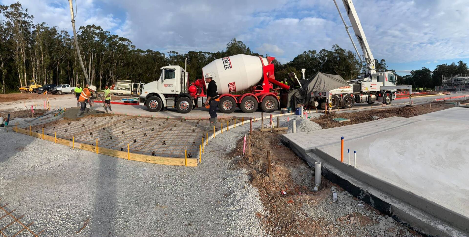 Cement Mixer and Excavator on Construction Site — AJ's Concreting Services in Taylors Beach, NSW