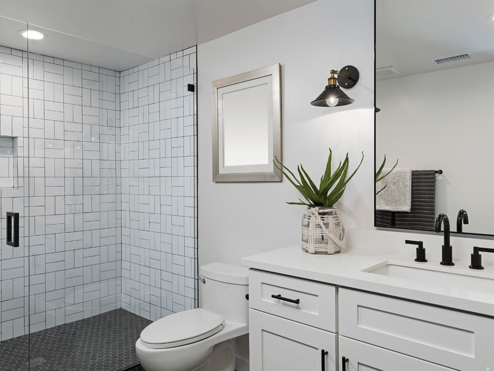 bathroom remodeling in baltimore with white cabinets and white tile shower