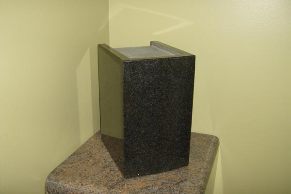 A black box is sitting on top of a wooden table.