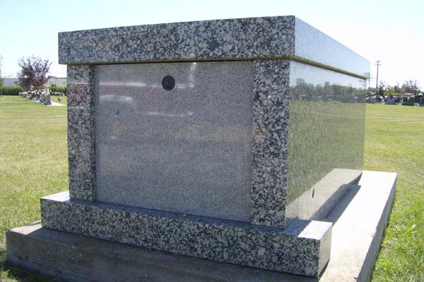 A grave in a cemetery with a hole in the middle