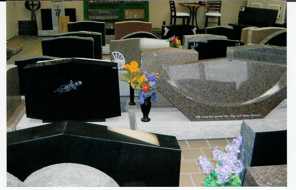 A vase of flowers sits in front of a display of gravestones