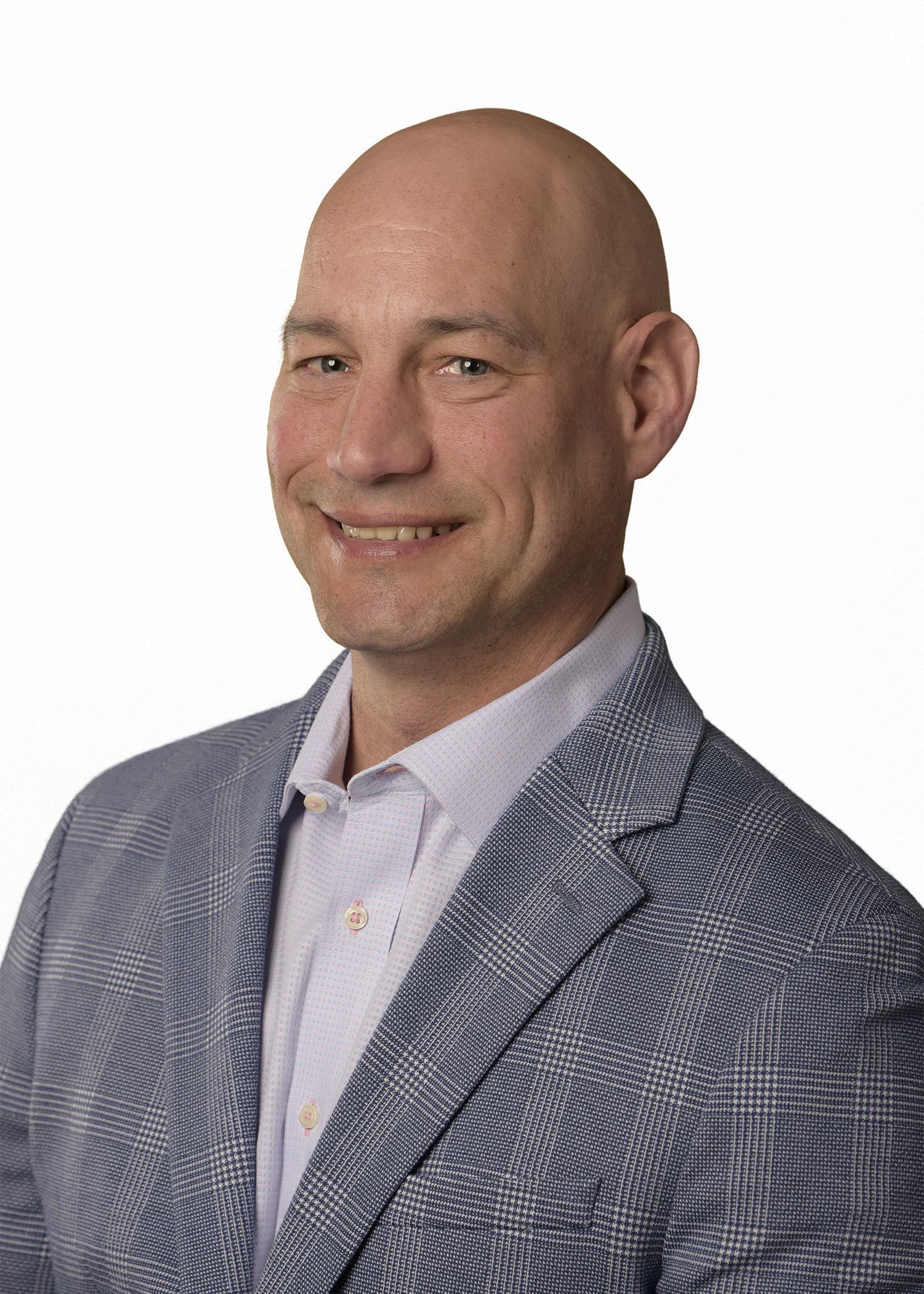 A man in a suit and tie is smiling for the camera