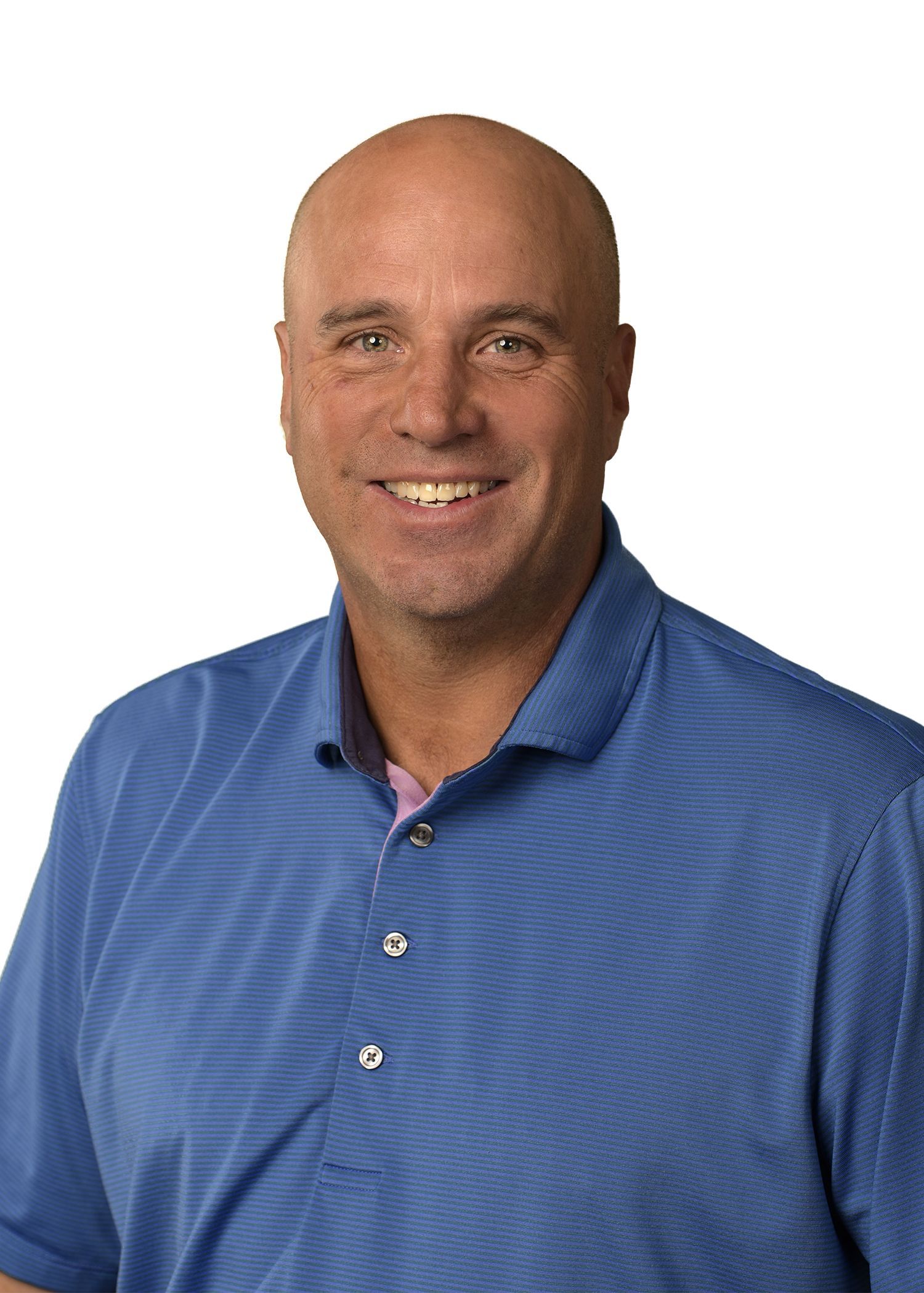 A man wearing a hat and a gray shirt is smiling for the camera.