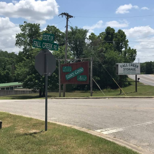 Storage units in a warehouse; a blue hand truck is in the aisle.