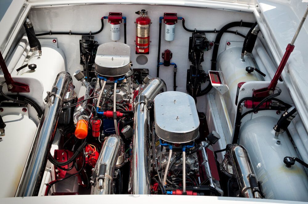 A Close Up Of A Boat Engine With A Fire Extinguisher On The Side — Mark's Outboards & More In Kurri Kurri, NSW